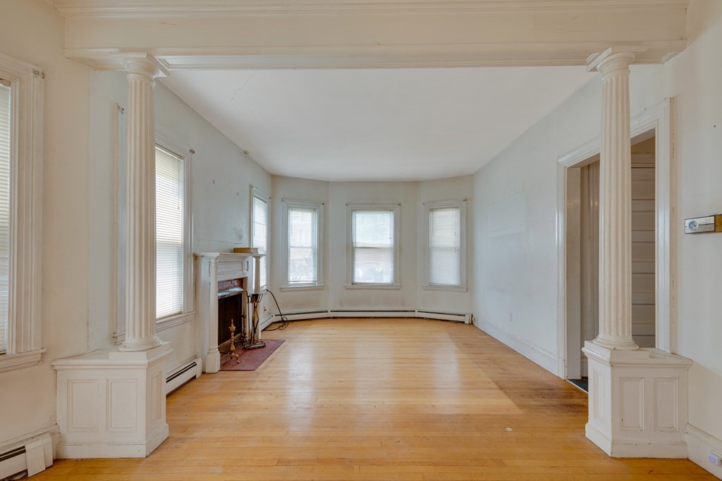33 Oak Street Boston, MA 02136 - Photo 9 of 18 a view of empty room with a fireplace and window