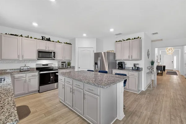 a kitchen with a refrigerator and a stove top oven