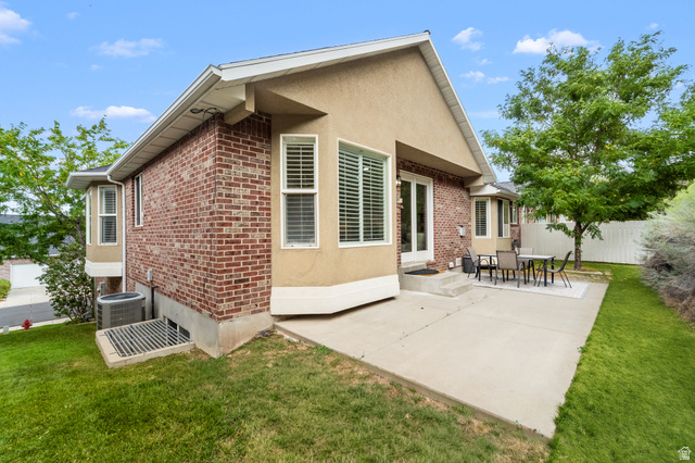 340 Brayden Way Draper, UT 84020 - Photo 48 of 58 Exterior featuring brick and stucco siding, bay windows, and a concrete patio