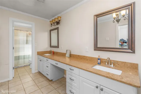 a spacious bathroom with a granite countertop sink a mirror and a vanity