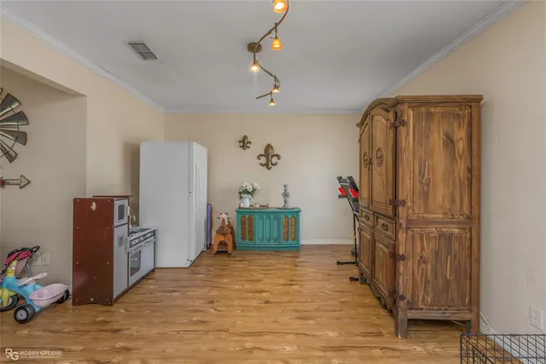a view of a hallway with closet and wooden floor