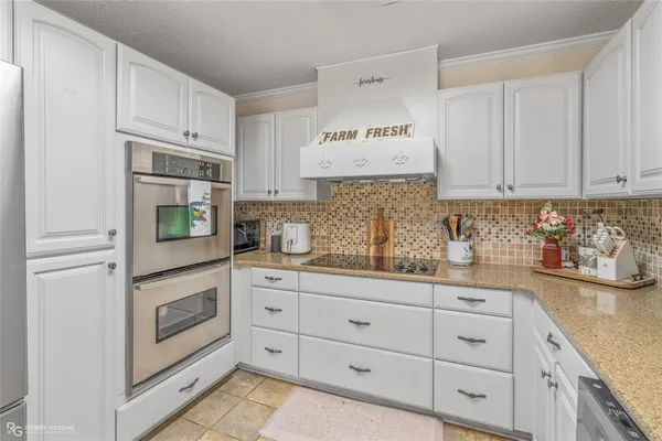 a kitchen with stainless steel appliances a refrigerator and cabinets
