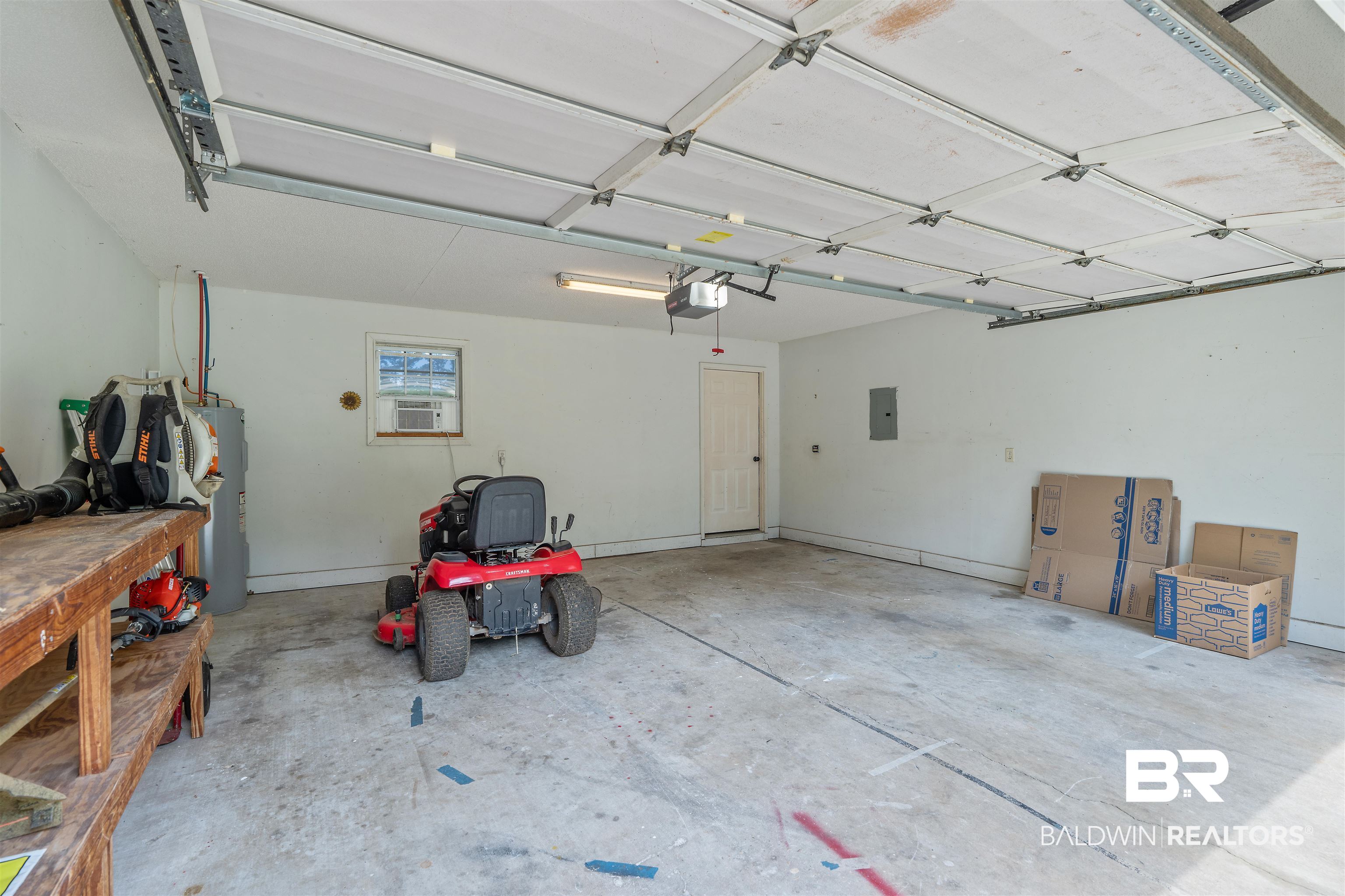 25779 Austin Road Daphne, AL 36526 - Photo 15 of 30 Garage with a garage door opener, electric water heater, electric panel, and cooling unit