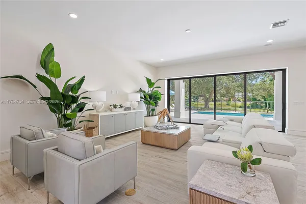 a living room with furniture and a potted plant