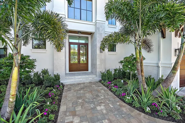 a kitchen with stainless steel appliances a sink a stove a refrigerator cabinets and a counter top space