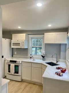 a kitchen with stainless steel appliances a sink stove and cabinets