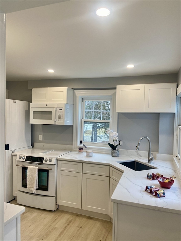 25 Clark Street, Unit 1 Arlington, MA 02476 - Photo 2 of 10 a kitchen with stainless steel appliances a sink stove and cabinets
