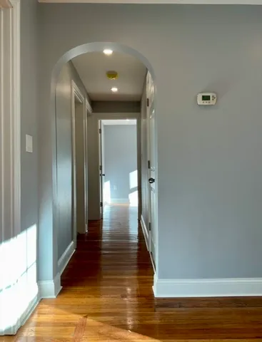 a view of hallway with wooden floor