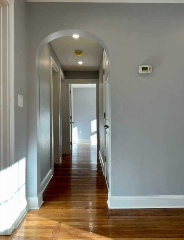 25 Clark Street, Unit 1 Arlington, MA 02476 - Photo 5 of 10 a view of hallway with wooden floor