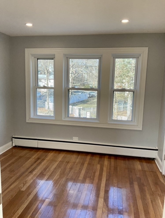 25 Clark Street, Unit 1 Arlington, MA 02476 - Photo 7 of 10 a view of an empty room with wooden floor and a window