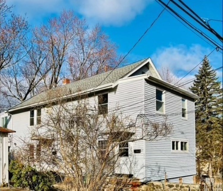25 Clark Street, Unit 1 Arlington, MA 02476 - Photo 10 of 10 a view of a white house with a large tree