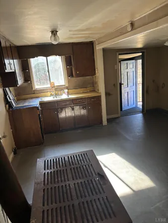 a view of kitchen with stove and cabinets