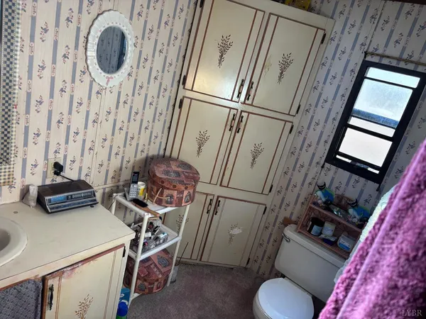 a view of storage and utility room with two washing machine