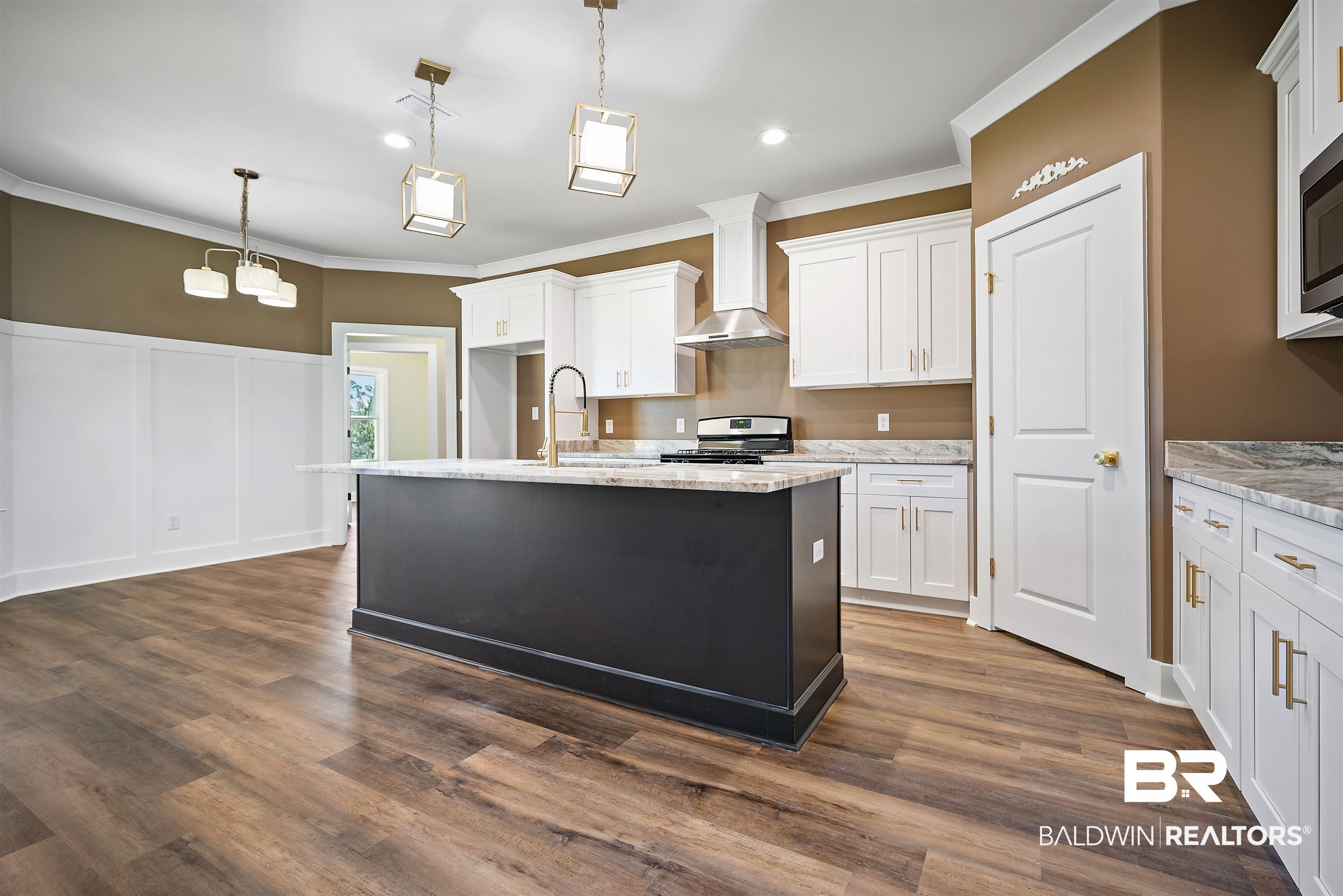 188 Hampton Ridge Mobile, AL 36608 - Photo 8 of 37 Kitchen featuring hanging light fixtures, white cabinetry, stainless steel appliances, and wall chimney exhaust hood