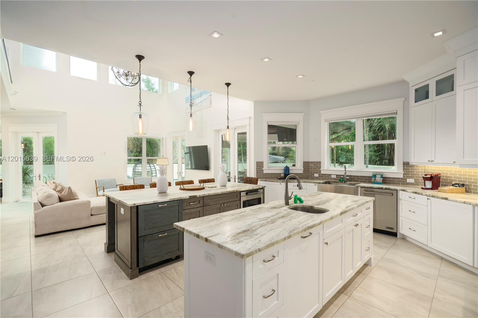 545 Southwest Indianola Street Stuart, FL 34994 - Photo 5 of 64 a large kitchen with kitchen island a large window in it