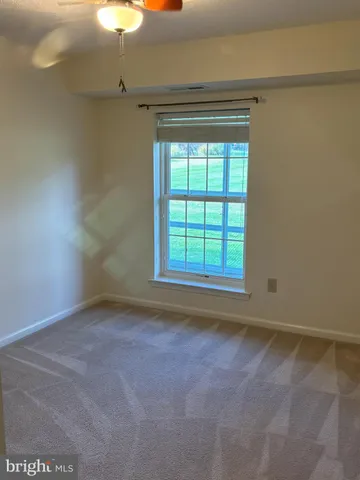 an empty room with a empty space and windows