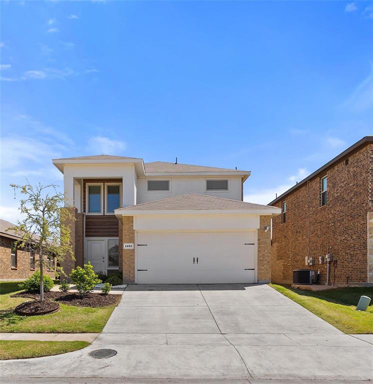1287 Delmita Drive, Unit 1287 Forney, TX 75126 - Photo 1 of 23 View of front facade featuring brick siding, concrete driveway, and an attached garage
