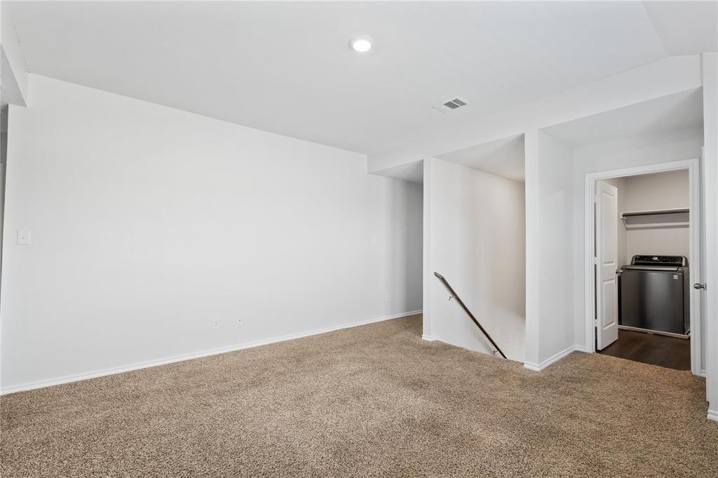 1287 Delmita Drive, Unit 1287 Forney, TX 75126 - Photo 13 of 23 Carpeted spare room featuring washer / dryer and baseboards