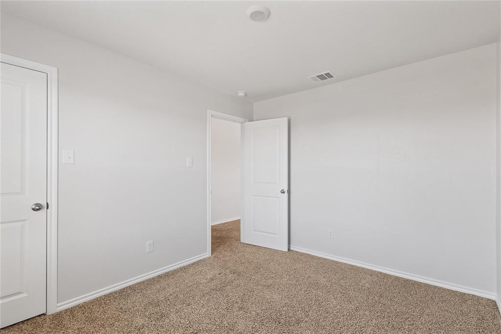 1287 Delmita Drive, Unit 1287 Forney, TX 75126 - Photo 17 of 23 Unfurnished bedroom featuring carpet and baseboards