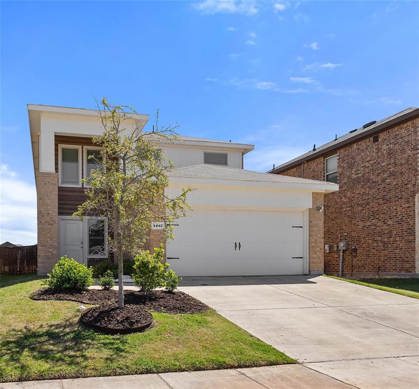 1287 Delmita Drive, Unit 1287 Forney, TX 75126 - Photo 2 of 23 View of front of home featuring concrete driveway and a garage