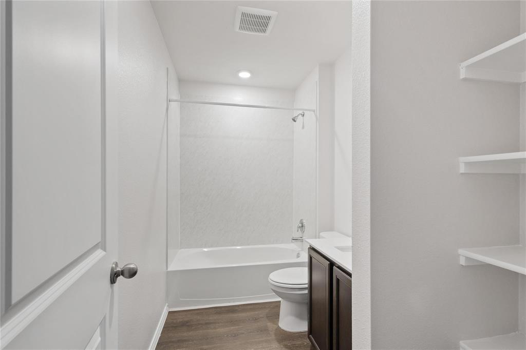 1287 Delmita Drive, Unit 1287 Forney, TX 75126 - Photo 18 of 23 Full bath with vanity, dark wood-style flooring, and shower / tub combination