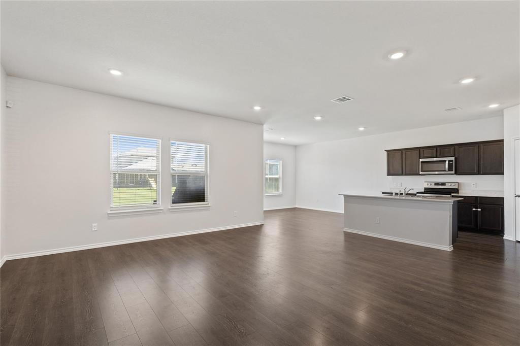 1287 Delmita Drive, Unit 1287 Forney, TX 75126 - Photo 4 of 23 Unfurnished living room with dark wood finished floors, plenty of natural light, and recessed lighting