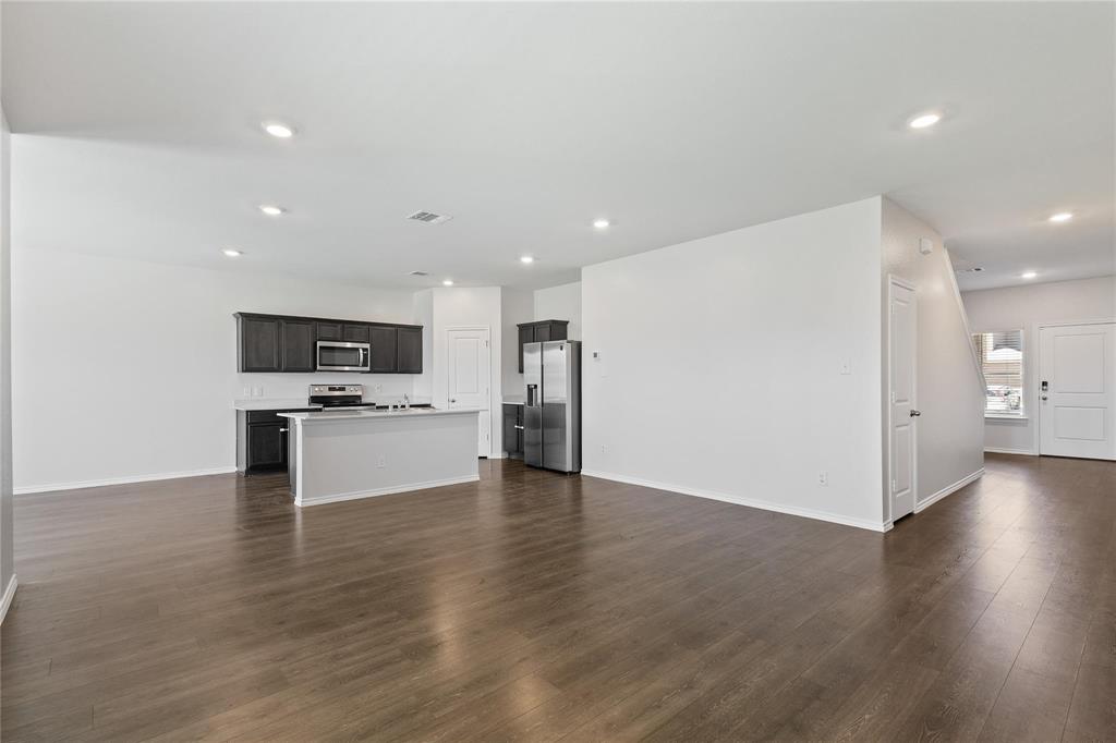 1287 Delmita Drive, Unit 1287 Forney, TX 75126 - Photo 5 of 23 Unfurnished living room with dark wood-style flooring and recessed lighting