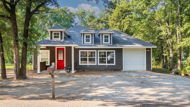 a view of a house with a patio and a yard