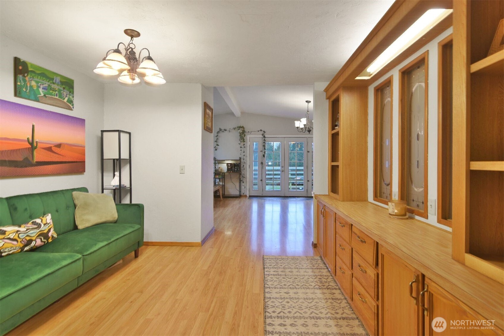 12611 Northeast 197th Street Bothell, WA 98011 - Photo 11 of 30 a view of a hallway with wooden floor and a chandelier
