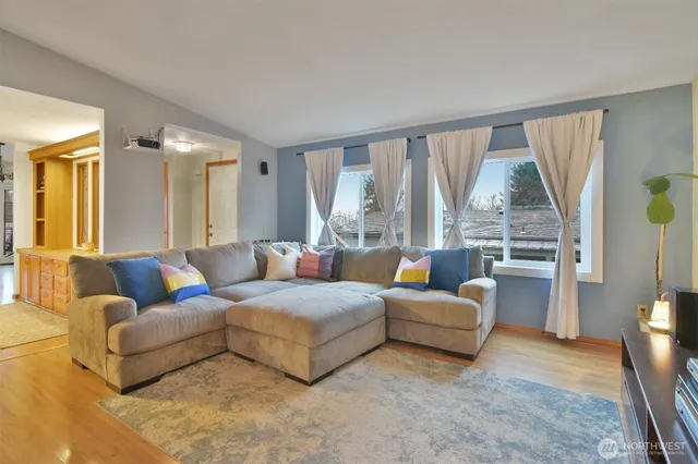 a living room with furniture and a large window