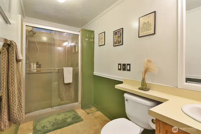 a bedroom with a bed and a large mirror on the dresser