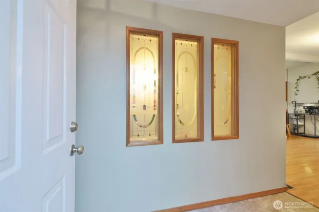 a view of a livingroom with furniture a dinning room and wooden floor