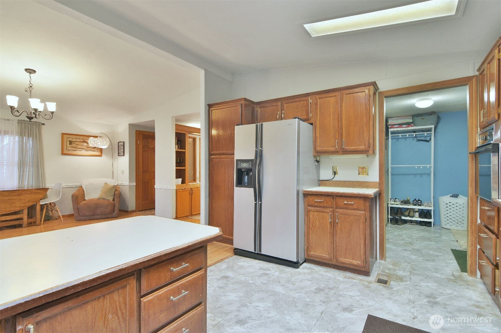 12611 Northeast 197th Street Bothell, WA 98011 - Photo 9 of 30 a kitchen with stainless steel appliances a refrigerator and cabinets