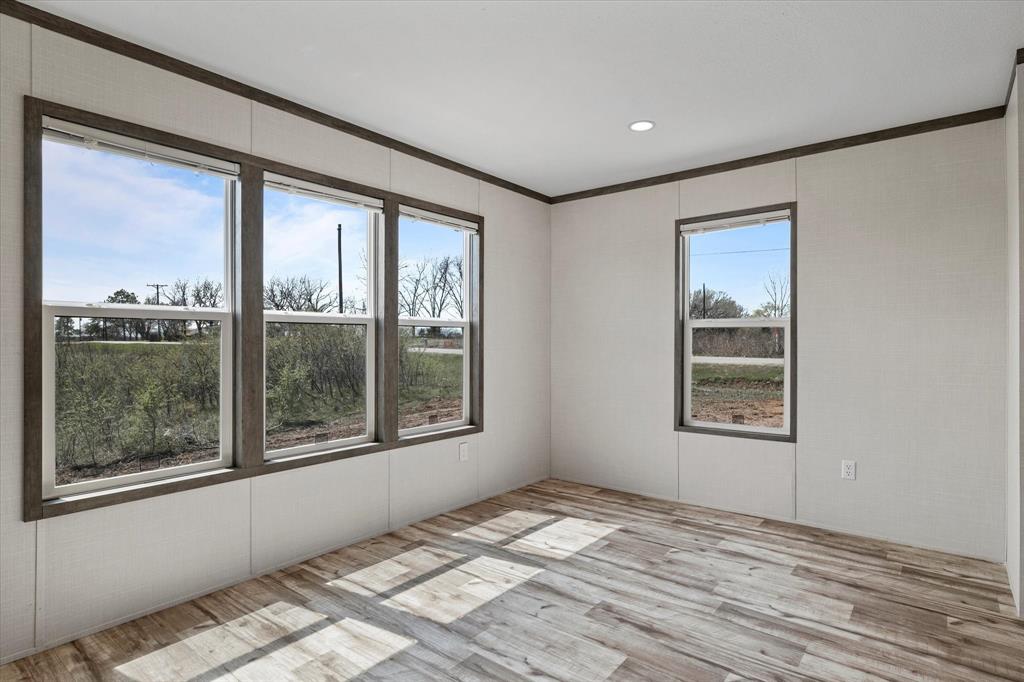 3924 Sandusky Road Whitesboro, TX 76273 - Photo 14 of 40 Unfurnished room featuring plenty of natural light and wood finished floors