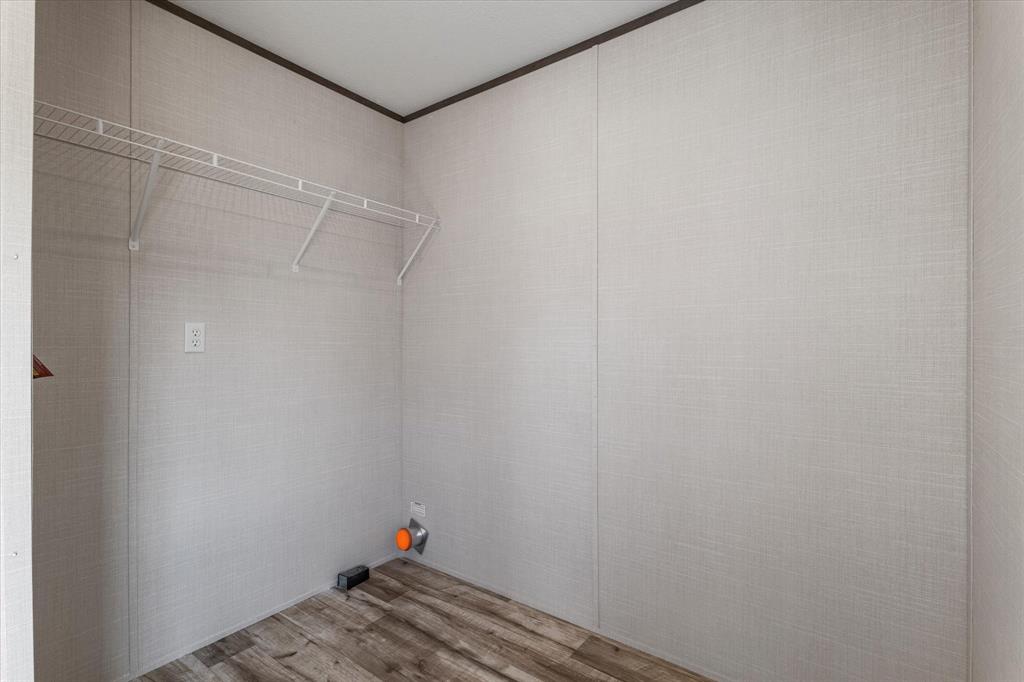 3924 Sandusky Road Whitesboro, TX 76273 - Photo 16 of 40 Washroom with wood finished floors, laundry area, and crown molding