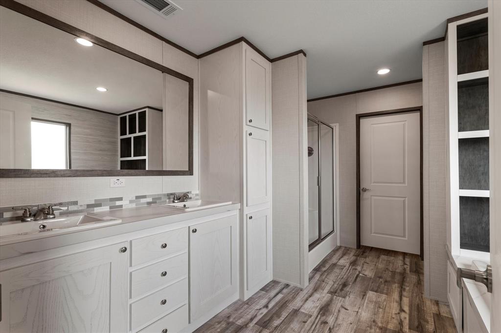 3924 Sandusky Road Whitesboro, TX 76273 - Photo 19 of 40 Bathroom with a shower stall, wood finished floors, and a sink