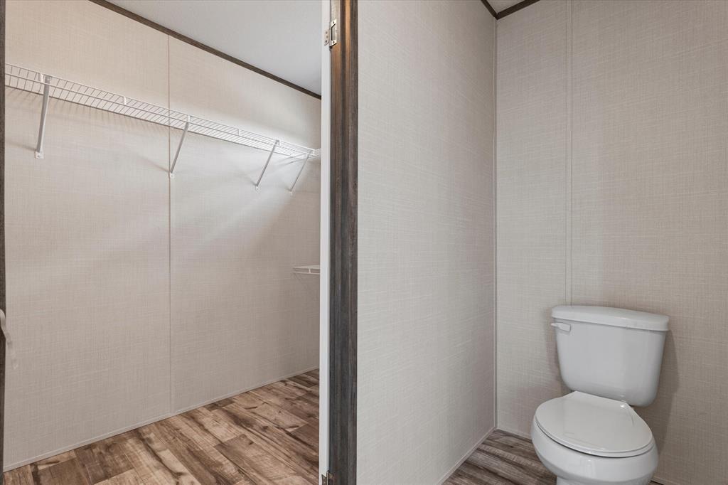 3924 Sandusky Road Whitesboro, TX 76273 - Photo 21 of 40 Bathroom with toilet and wood finished floors