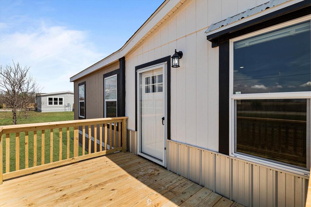 3924 Sandusky Road Whitesboro, TX 76273 - Photo 5 of 40 Wooden terrace with a lawn