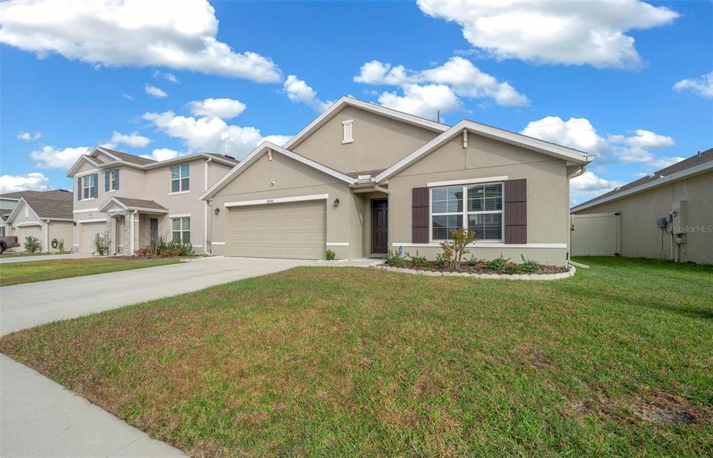 a view of a house with a large space and a yard