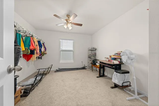a view of a workspace with furniture and a window