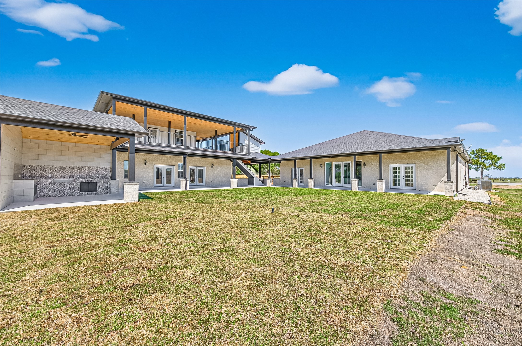 12212 Padon Road Needville, TX 77461 - Photo 29 of 37 View of porch, second story balcony and outdoor kitchen all you need is a pool