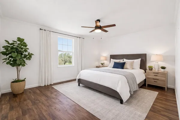 a bedroom with a bed and a potted plant