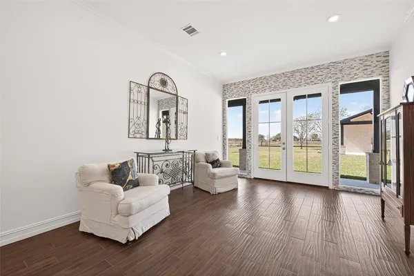 a living room with furniture and wooden floor