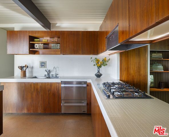 a kitchen with a stove and a refrigerator