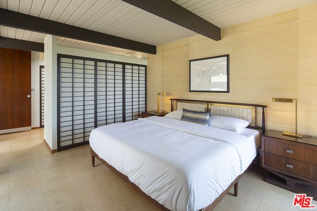 a bedroom with a bed and lamp