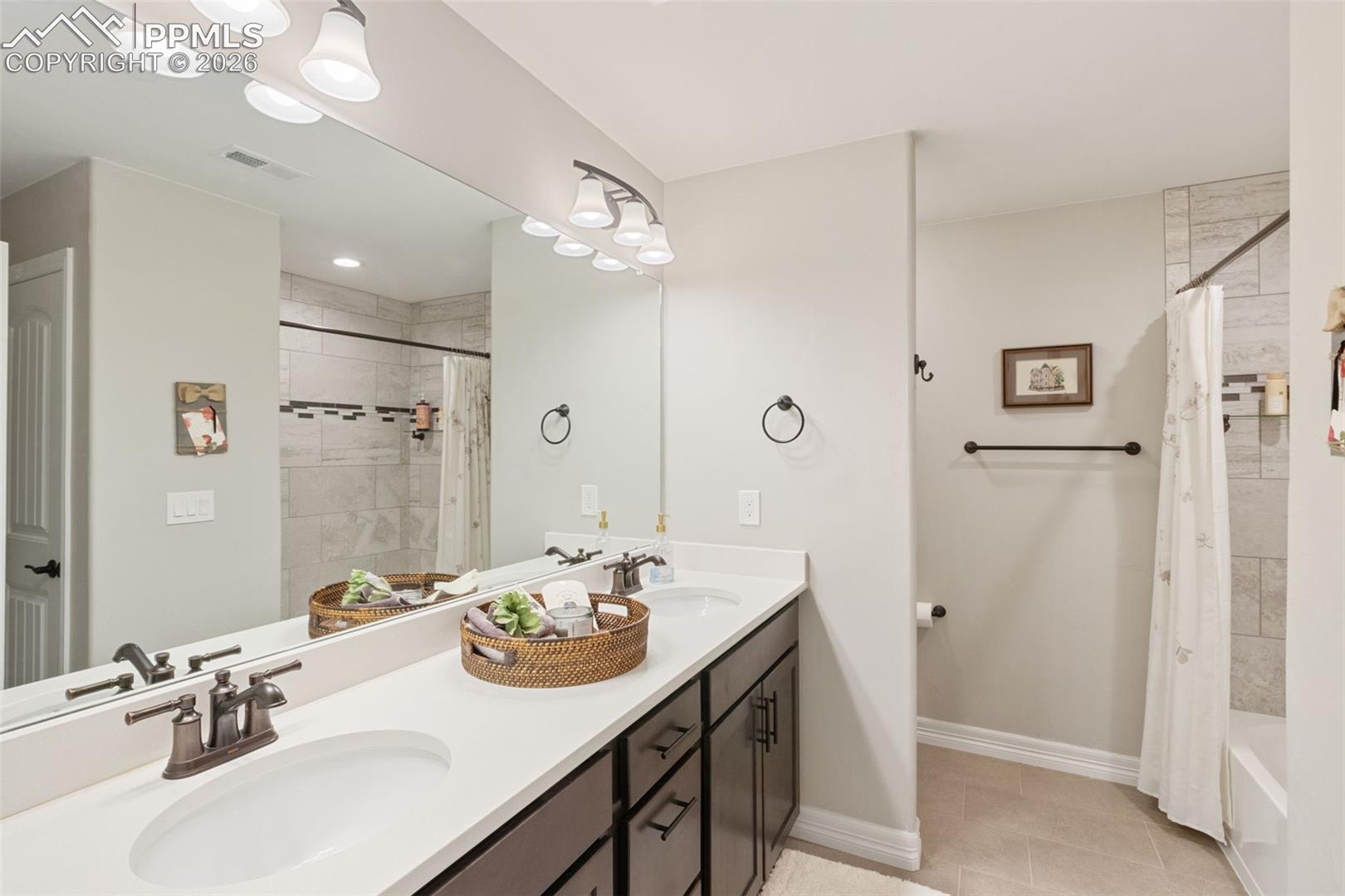5318 Rocking Tree Grove Colorado Springs, CO 80906 - Photo 34 of 49 The basement bathroom is appointed with the same level of luxury as the main floors, featuring a double vanity and shower/tub combo