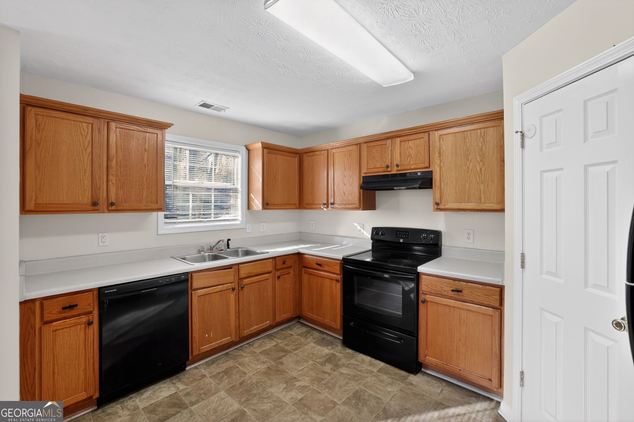 4375 Conley Landing Conley, GA 30288 - Photo 24 of 34 a kitchen with stainless steel appliances granite countertop white cabinets sink stove and granite counter top