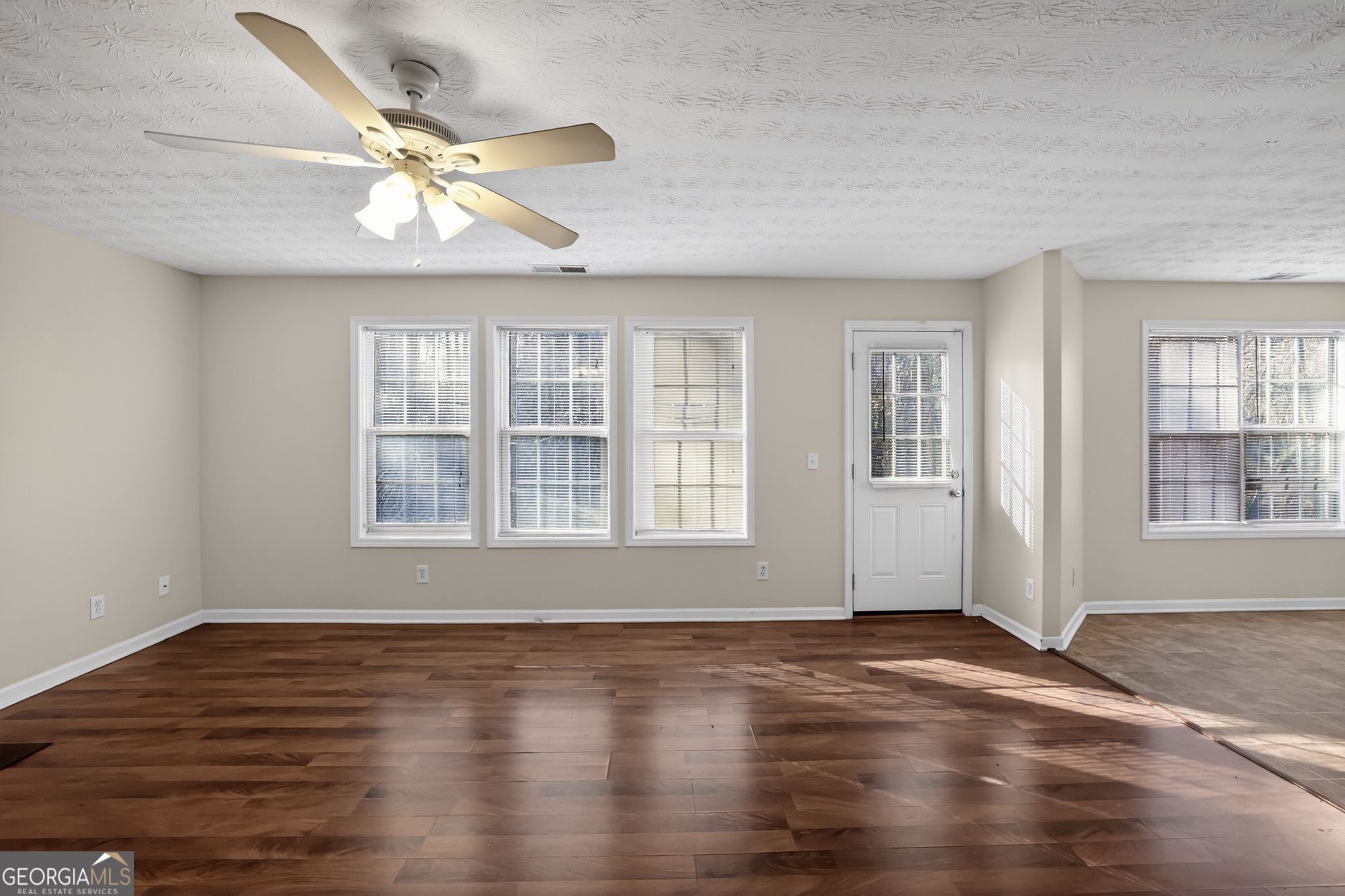 4375 Conley Landing Conley, GA 30288 - Photo 7 of 34 a view of an empty room with wooden floor and a window
