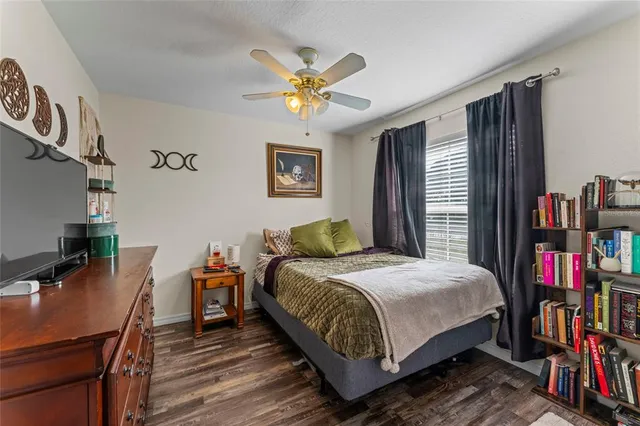 a bedroom with a bed bookshelf and a desk in it