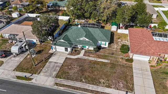 an aerial view of residential houses with outdoor space